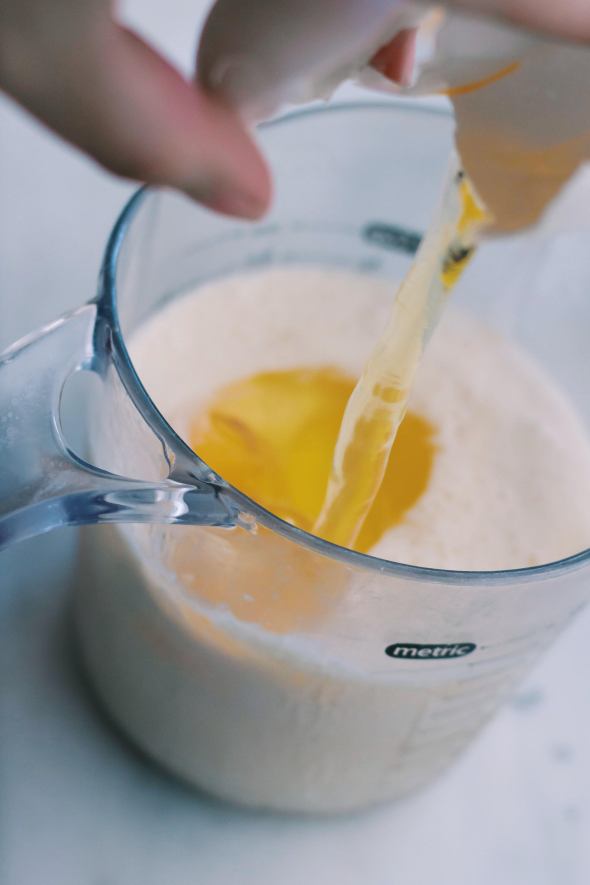 cracking eggs into cream